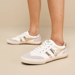 Gola Badminton plimsoll sneaker in the white and gold colorway. 
Anthropologie